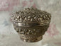 An antique silver south East Asian round box with lid