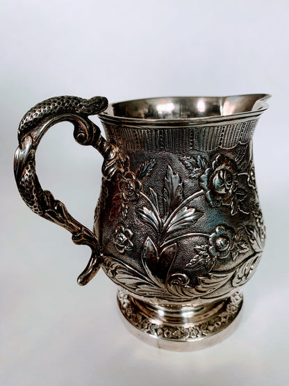 A silver creamer (roses)
