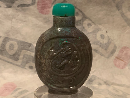 A carved opal snuff bottle with a jade stopper