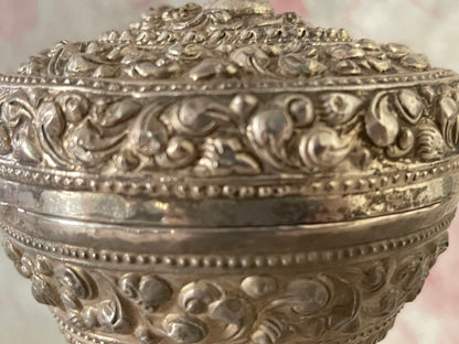 An antique silver south East Asian round box with lid