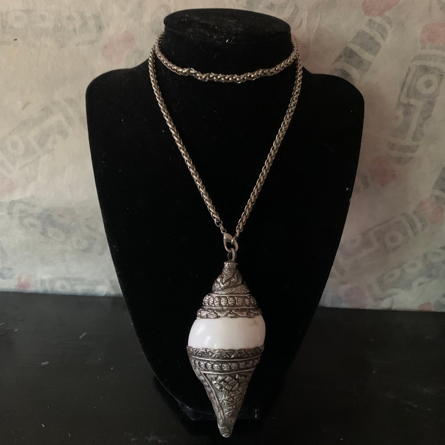 A vintage silver naga conch shell pendant