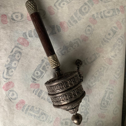 An antique Tibetan handheld prayer wheel