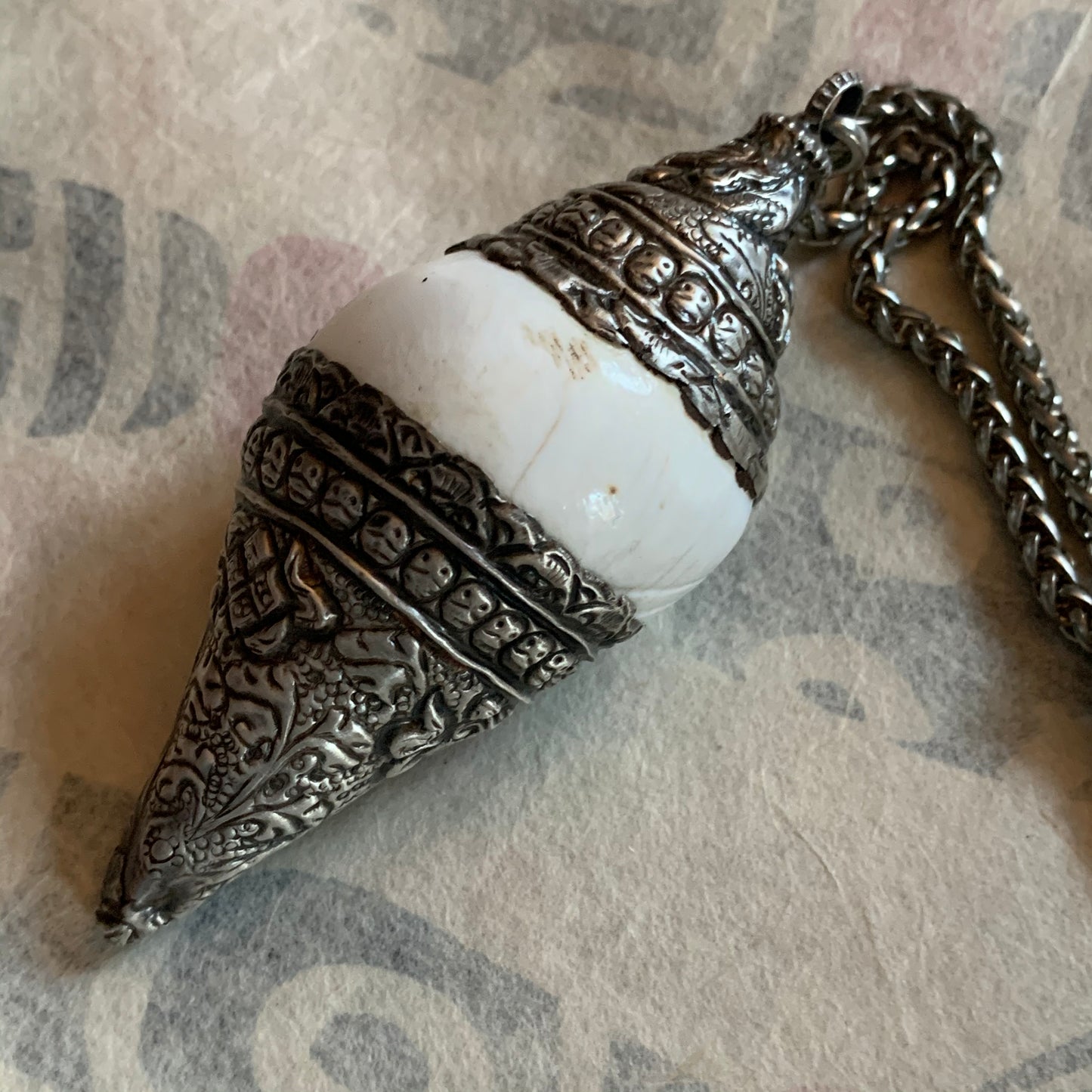 A vintage silver naga conch shell pendant