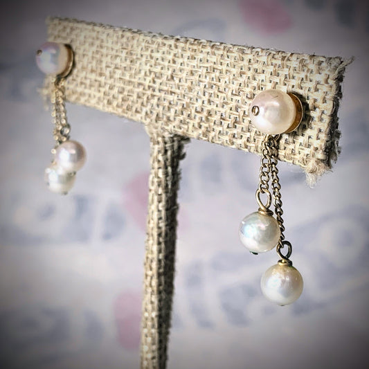 A pair of pearl and gold earrings