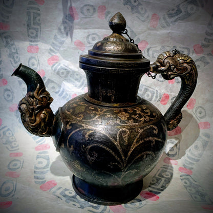 An antique Tibetan iron and silver teapot
