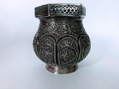 An exquisitely carved antique silver utensil -possibly a censer with floral details