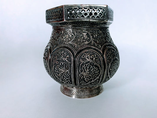 An exquisitely carved antique silver utensil -possibly a censer with floral details