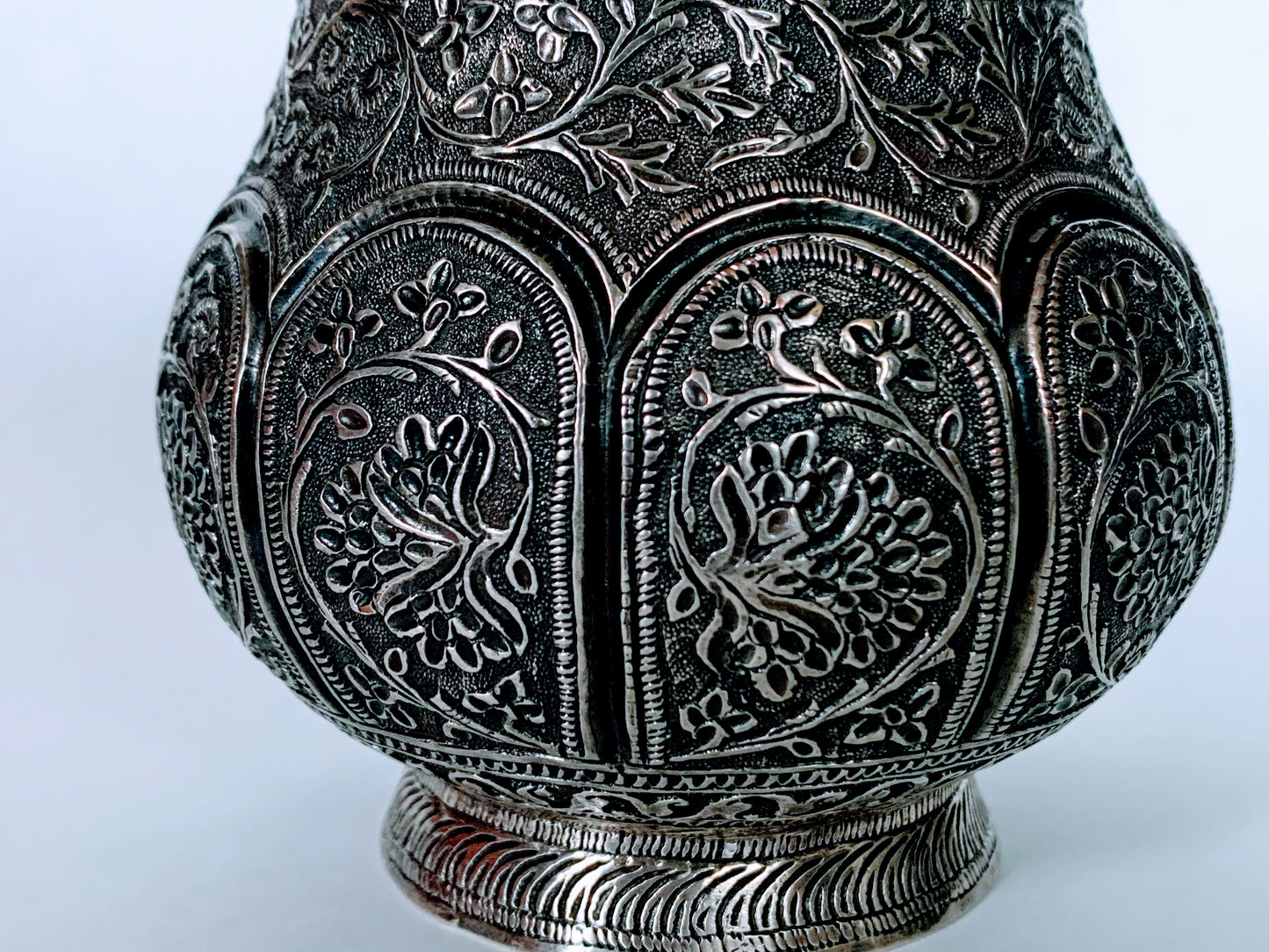 An exquisitely carved antique silver utensil -possibly a censer with floral details