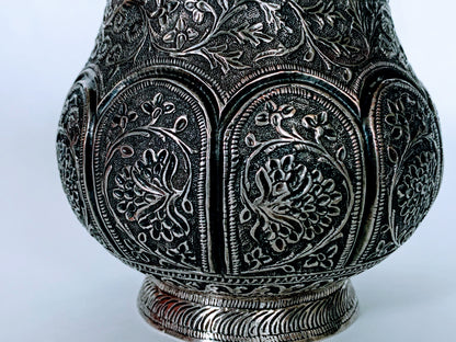 An exquisitely carved antique silver utensil -possibly a censer with floral details