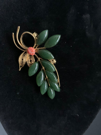 A jade and coral brooch