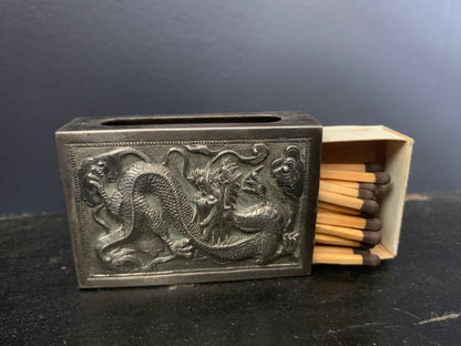 A silver matchbox cover
