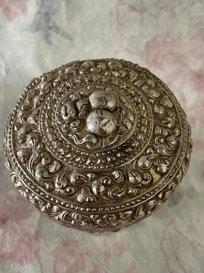 An antique silver south East Asian round box with lid