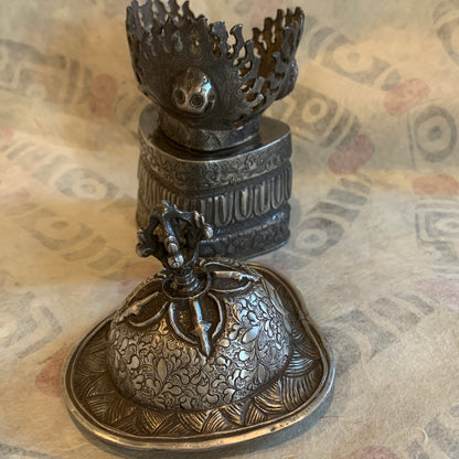An antique silver kapala stand and cover