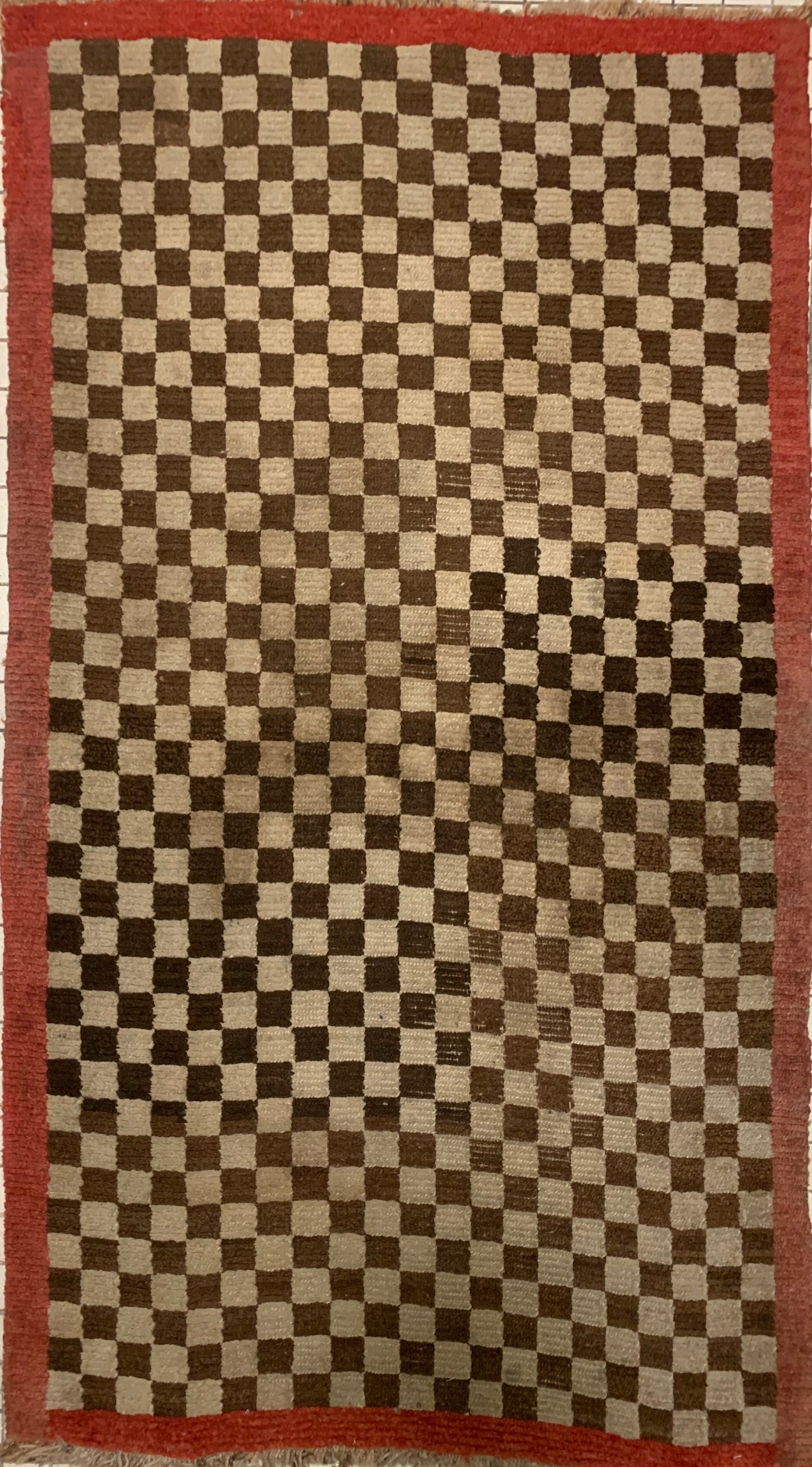 An antique Tibetan checkerboard rug