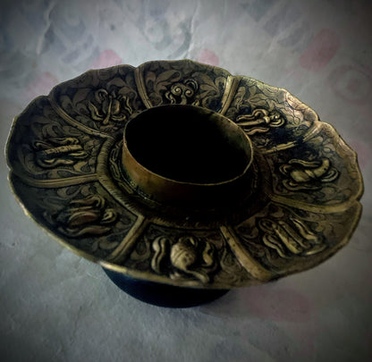 An antique metal cup stand