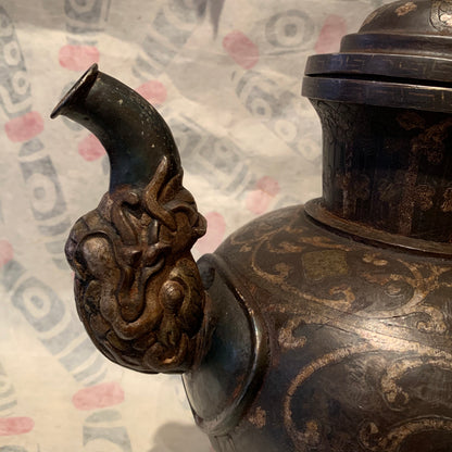 An antique Tibetan iron and silver teapot
