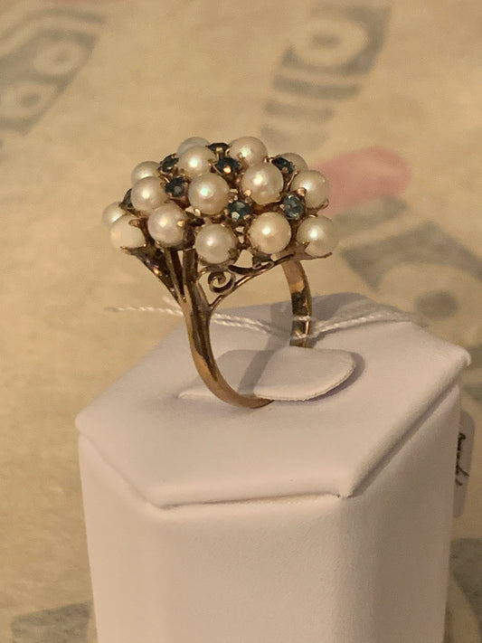 A pearl and sapphire ring in a 14kt setting