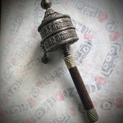 An antique Tibetan handheld prayer wheel