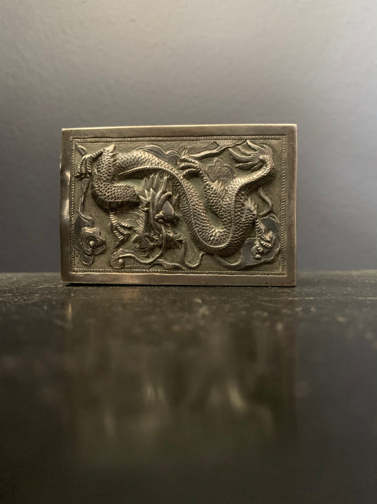 A silver matchbox cover