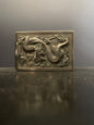 A silver matchbox cover