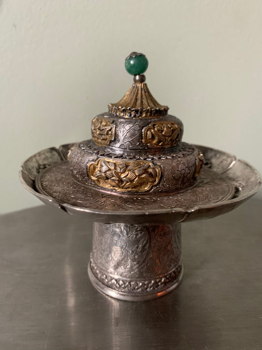 A silver cup stand