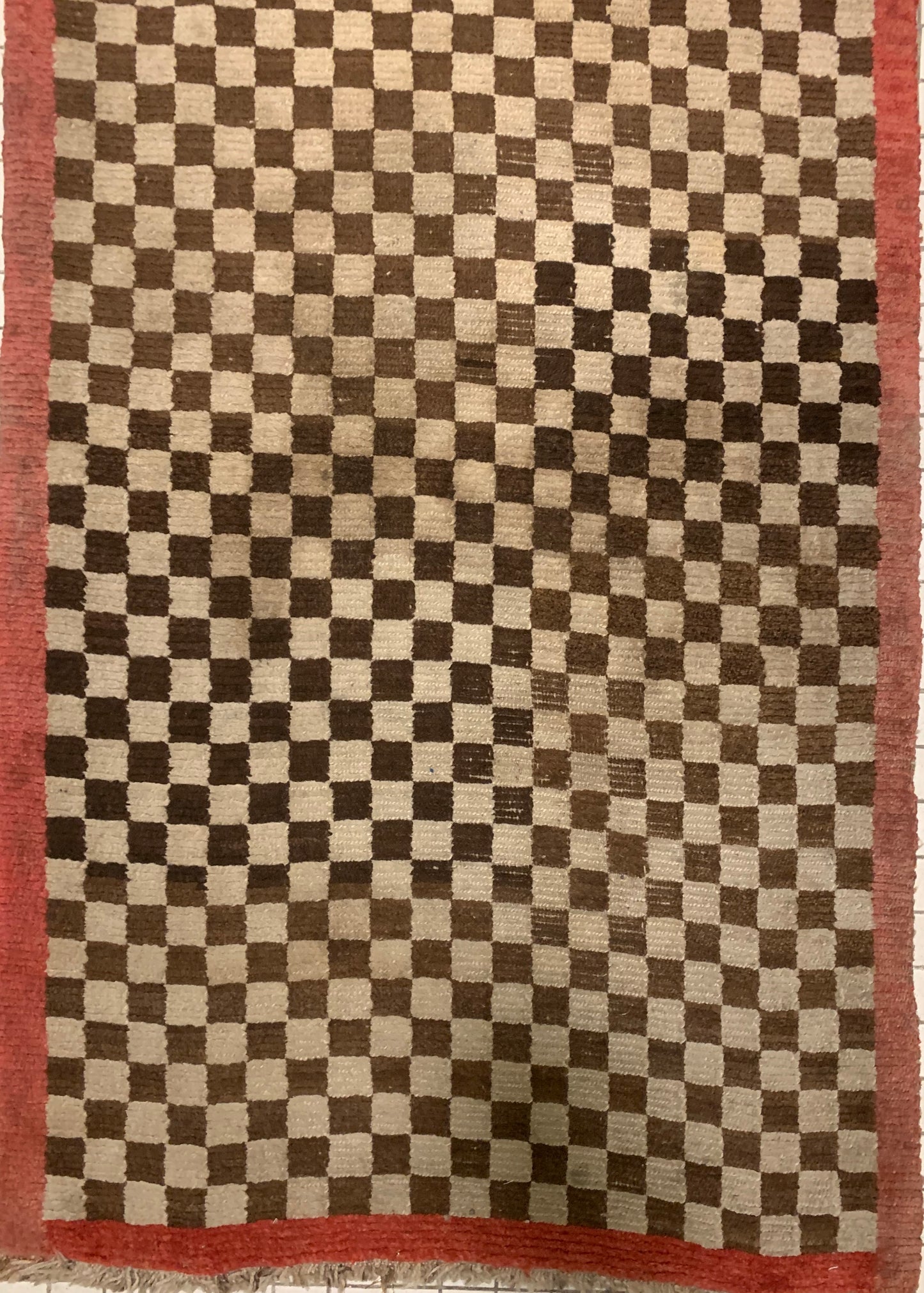 An antique Tibetan checkerboard rug