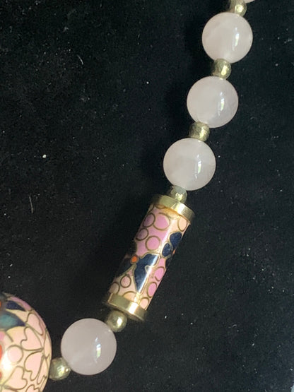 A necklace with rose quartz beads