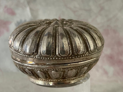 An antique silver south East Asian round box with lid