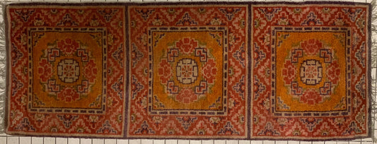 An antique triple seater Tibetan meditation rug