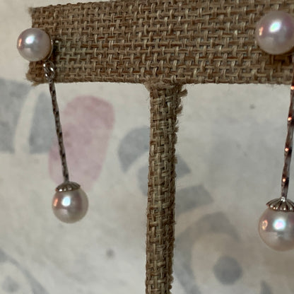 A pair of pearl dangling earrings
