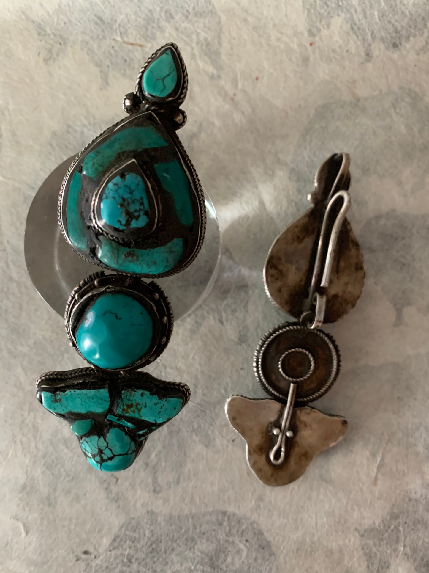 A pair of antique Tibetan turquoise and silver ear pendants / earrings