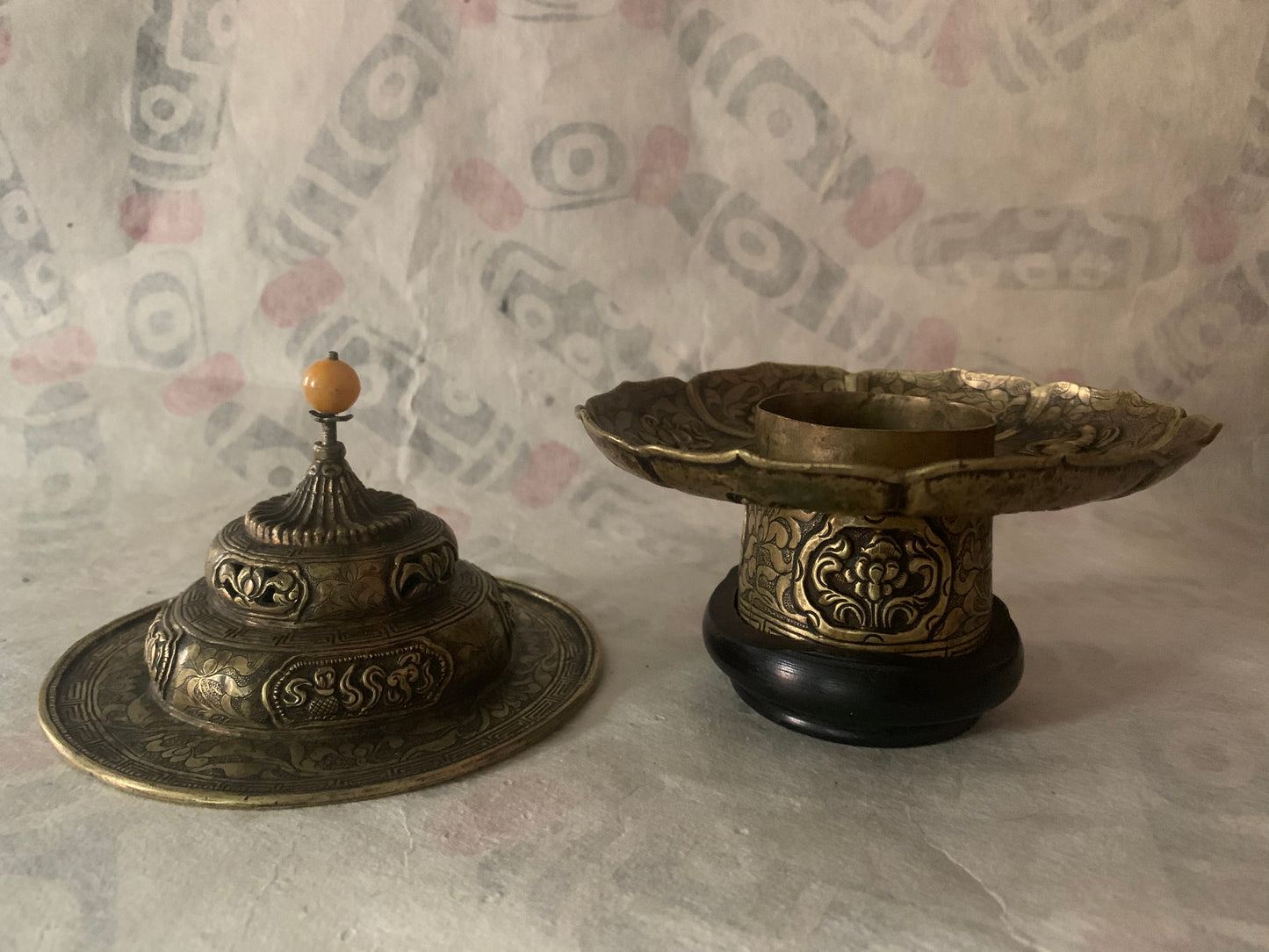 An antique metal cup stand