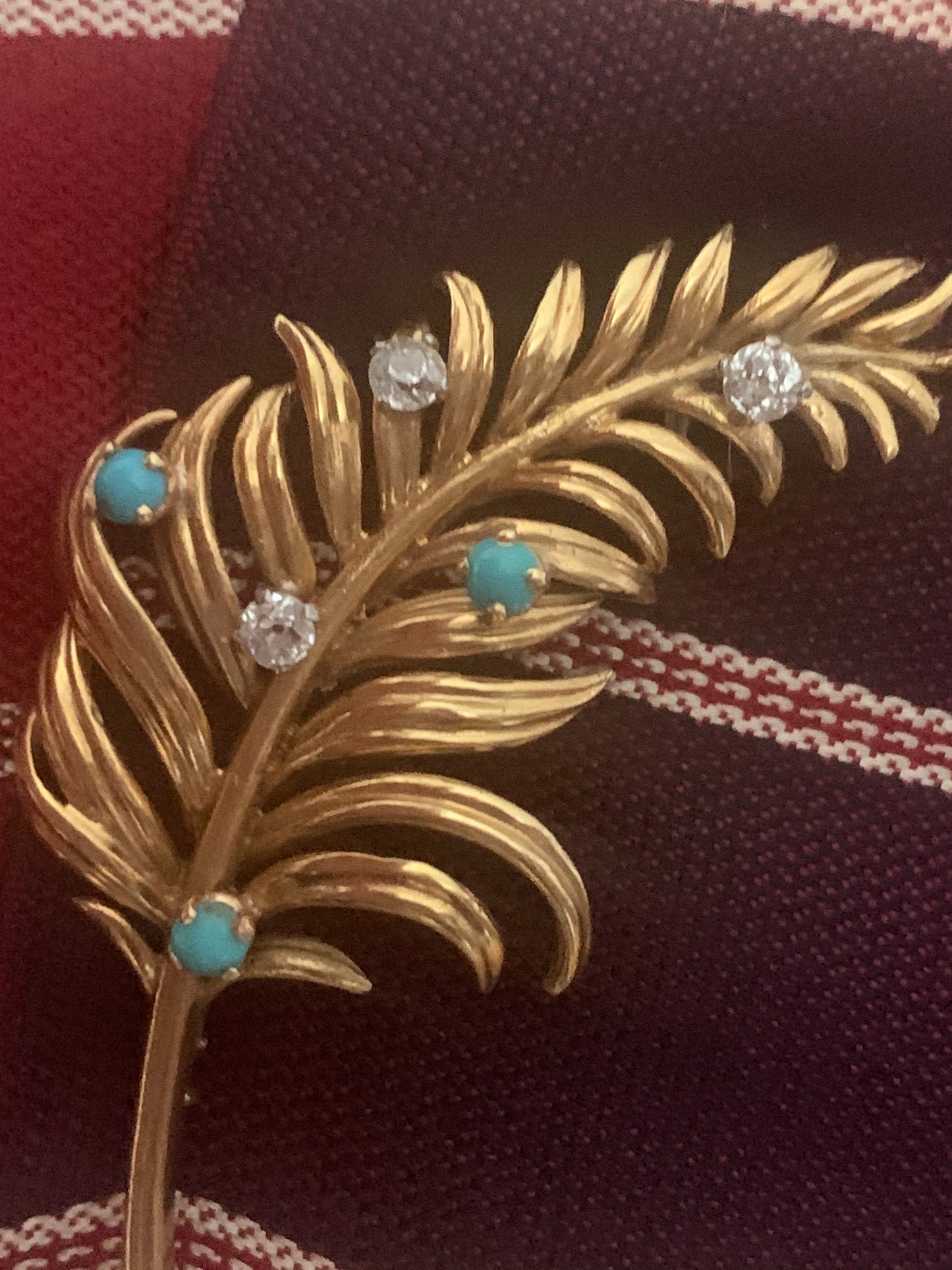A 18kt gold brooch with turquoise and diamonds.