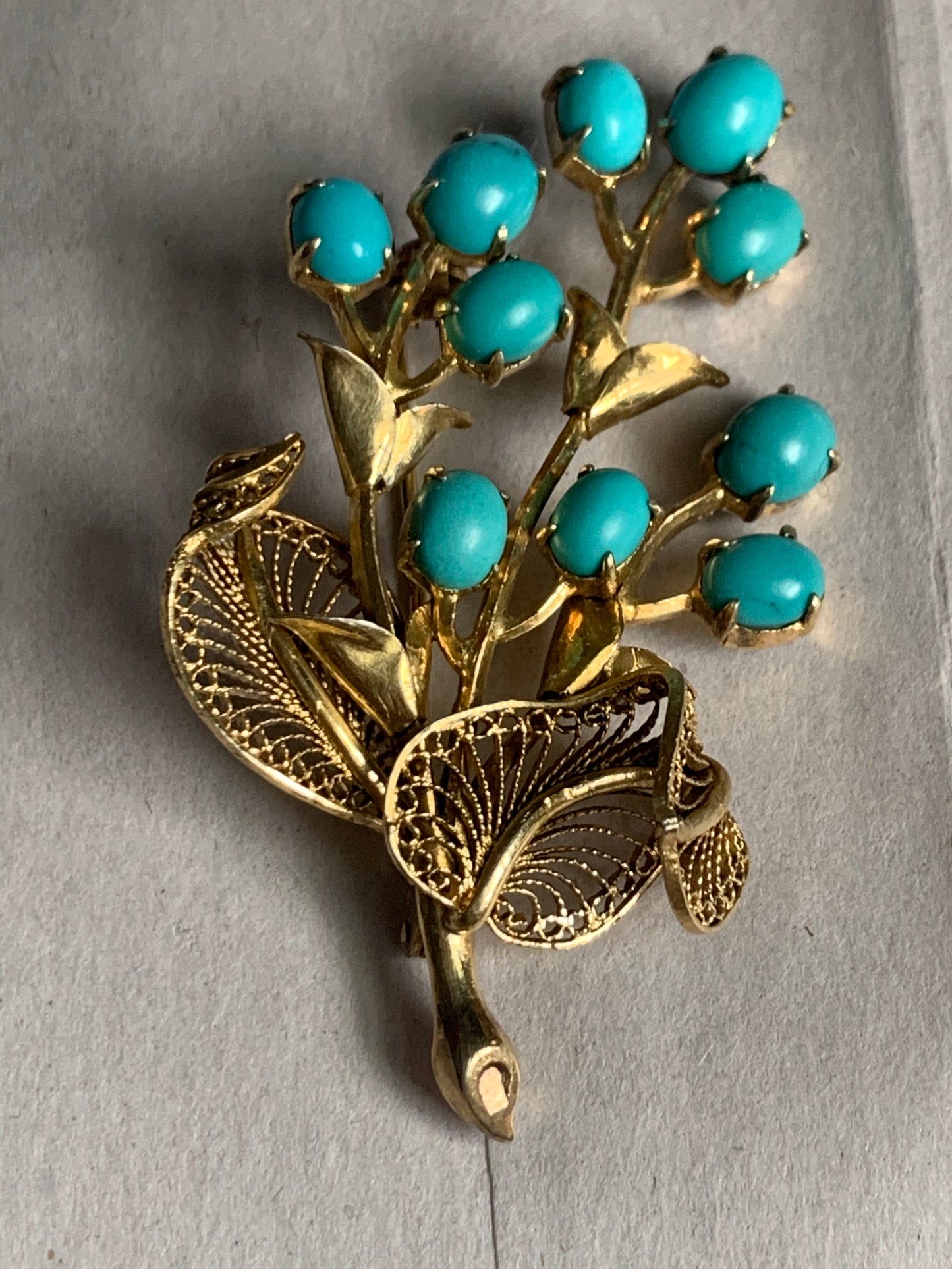 A turquoise brooch