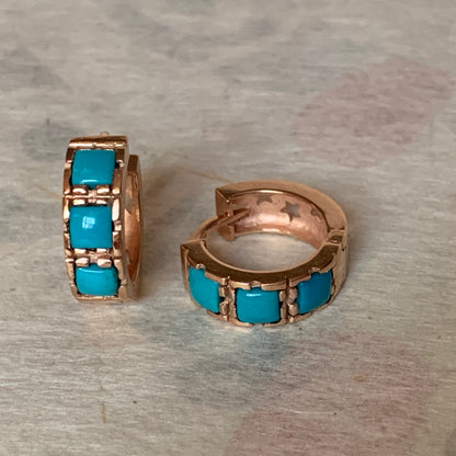 A pair of turquoise hoop earrings