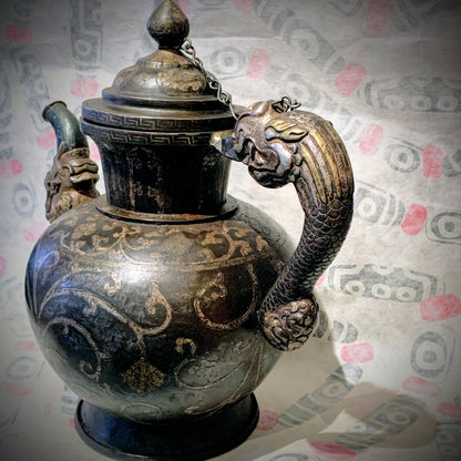 An antique Tibetan iron and silver teapot