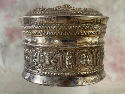 An antique silver south East Asian round box with lid