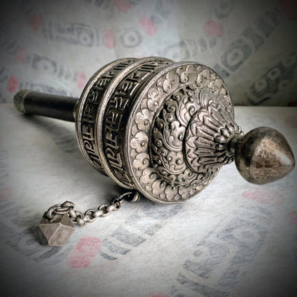 An antique Tibetan handheld prayer wheel