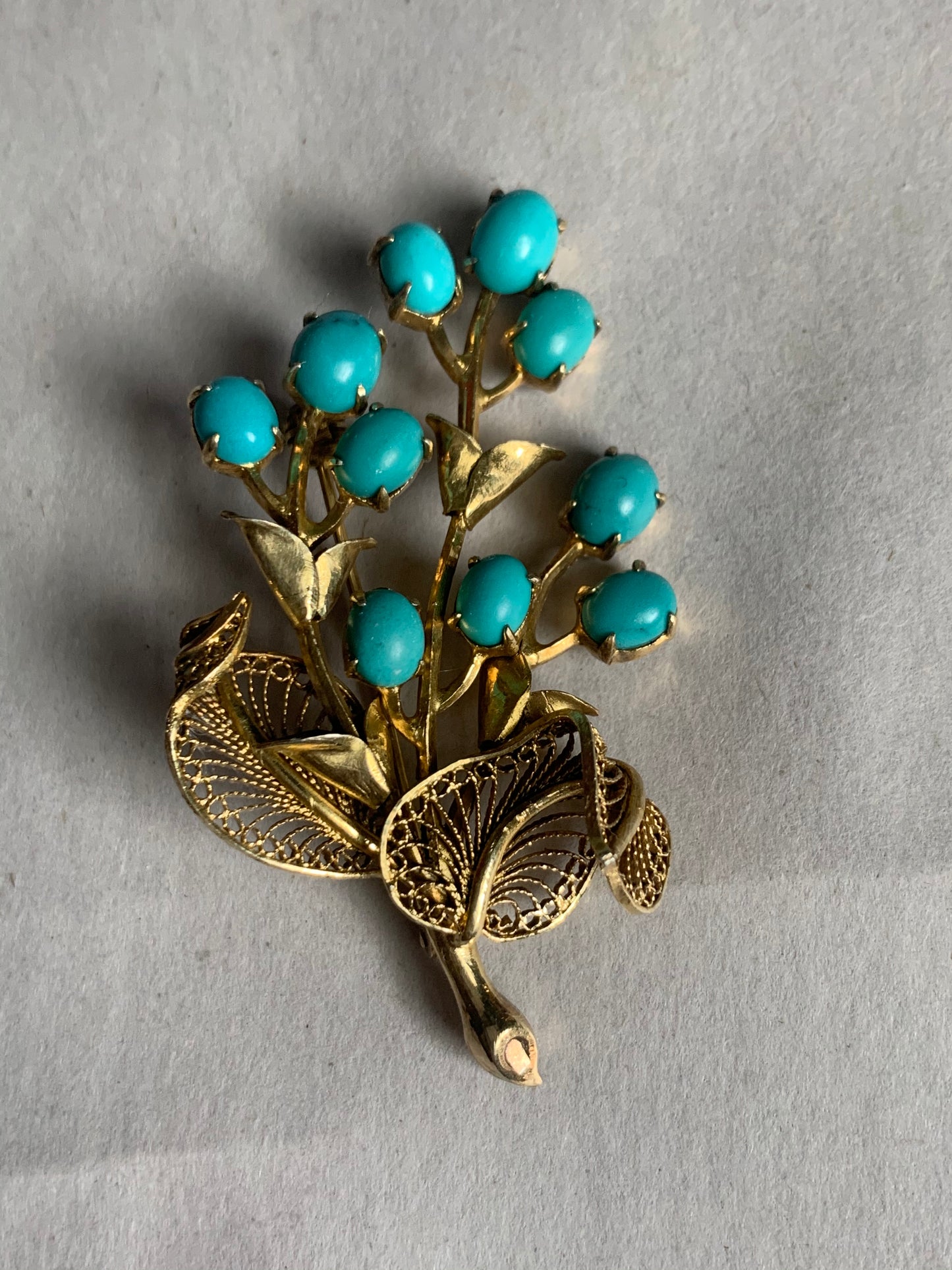 A turquoise brooch