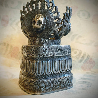 An antique silver kapala stand and cover