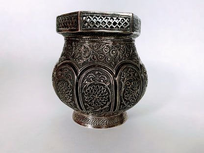 An exquisitely carved antique silver utensil -possibly a censer with floral details