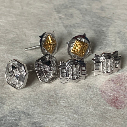 A set of three pairs of diamond ear studs in 10kt settings