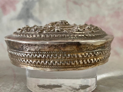 An antique silver south East Asian round box with lid