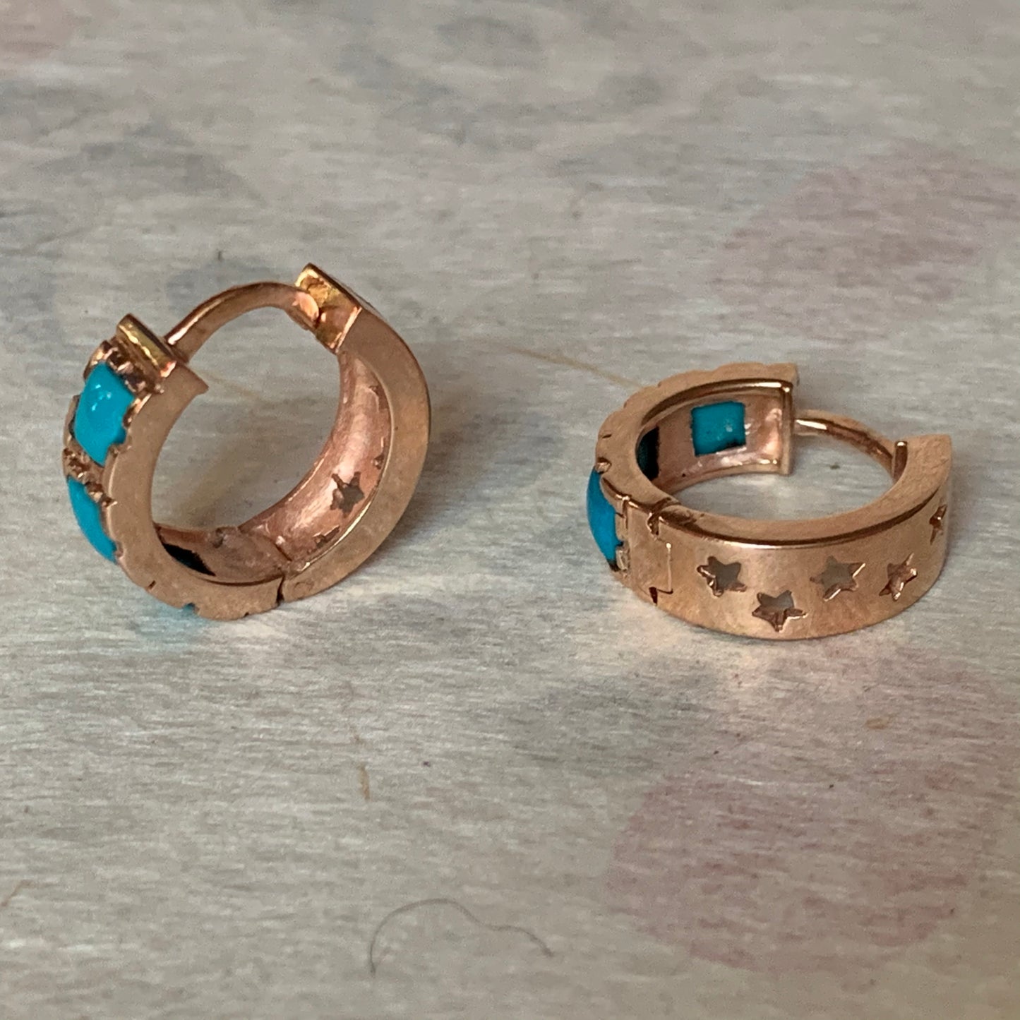 A pair of turquoise hoop earrings