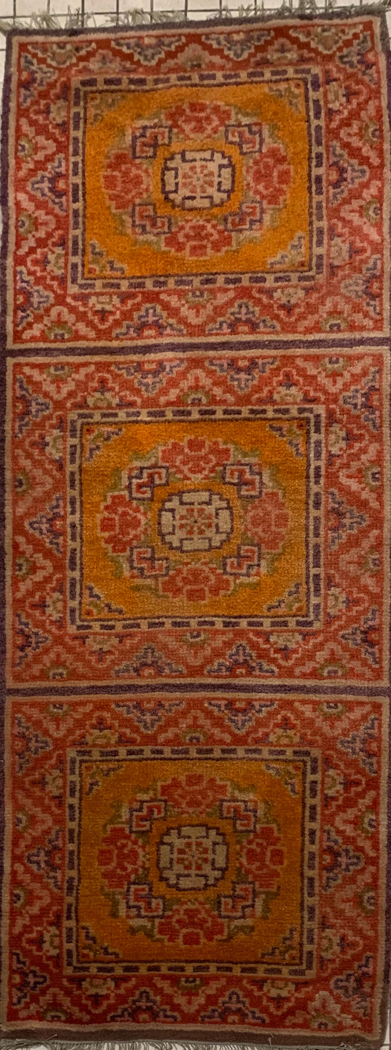 An antique triple seater Tibetan meditation rug