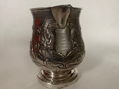 A silver creamer (roses)