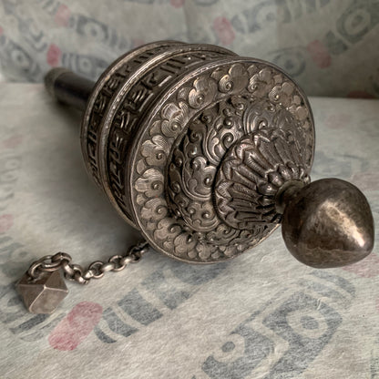An antique Tibetan handheld prayer wheel