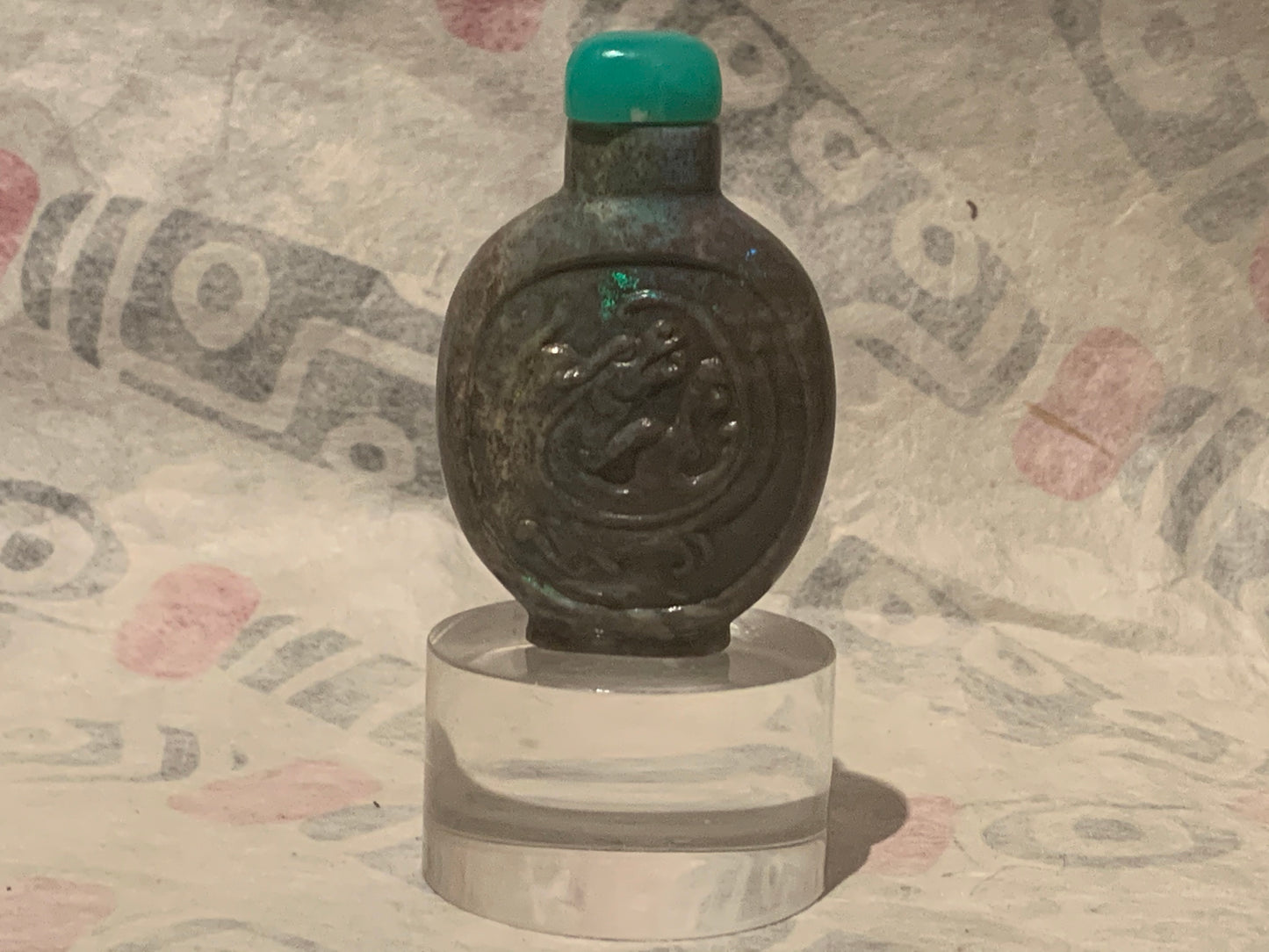 A carved opal snuff bottle with a jade stopper