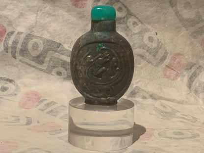 A carved opal snuff bottle with a jade stopper