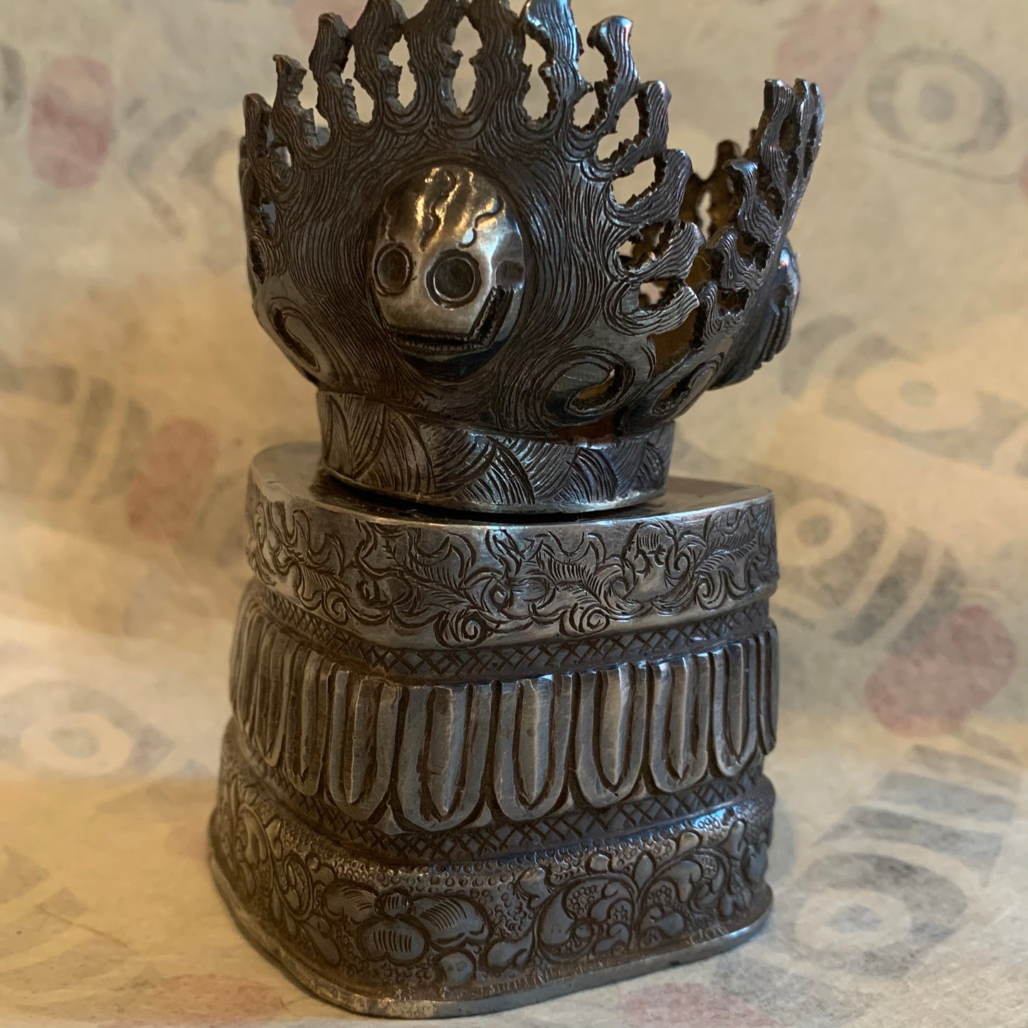 An antique silver kapala stand and cover